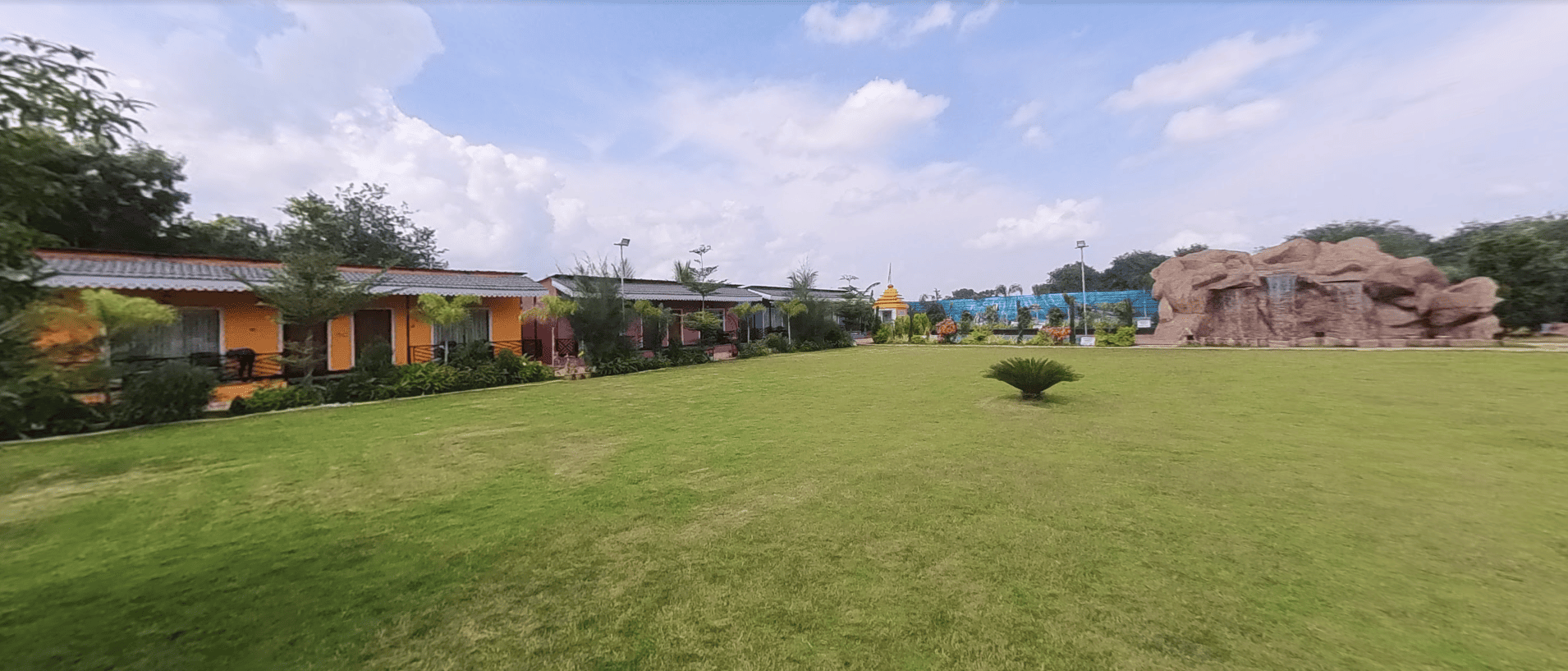 Akshat Green Resort lawn cottages and waterfall